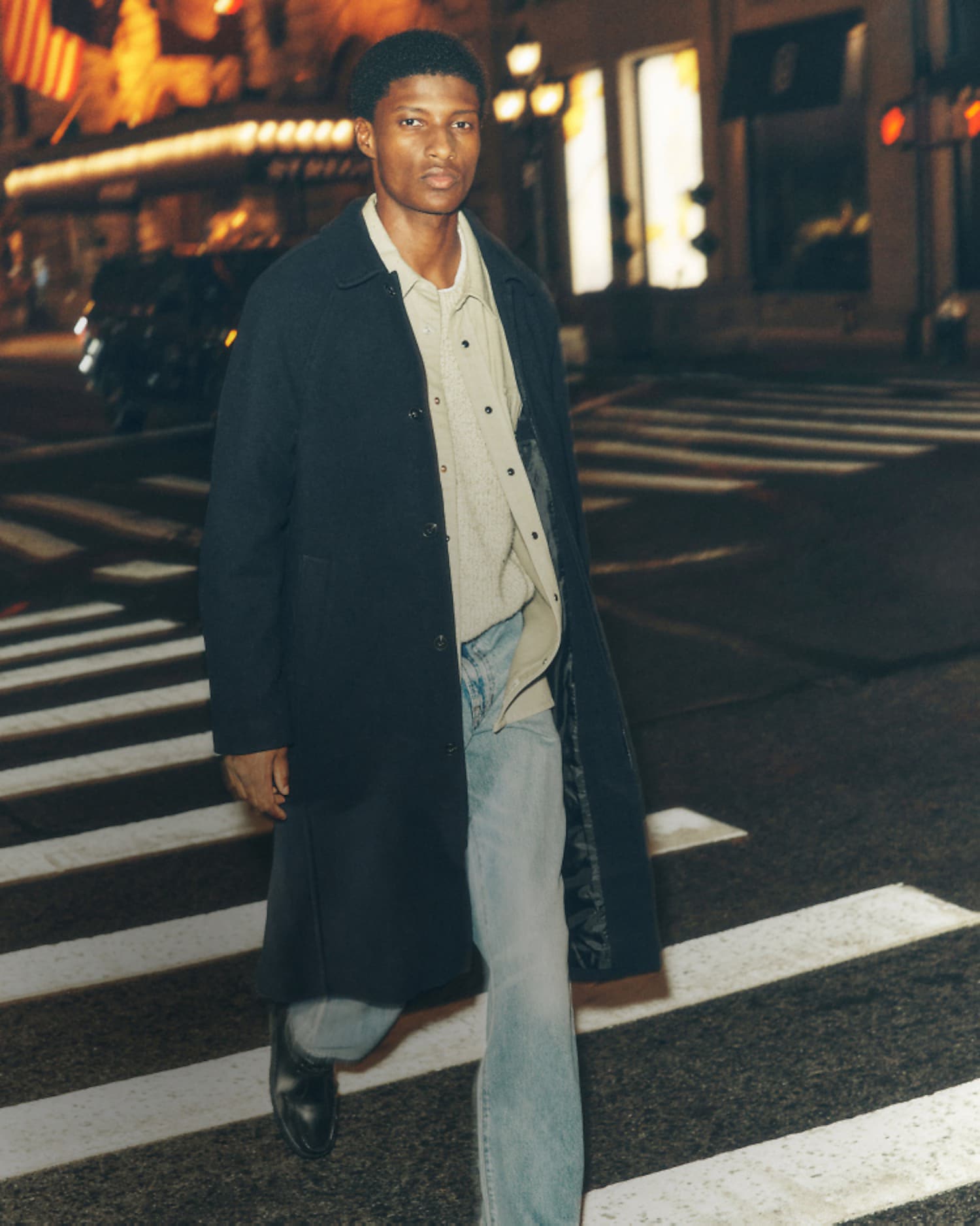 man wearing coat and jeans