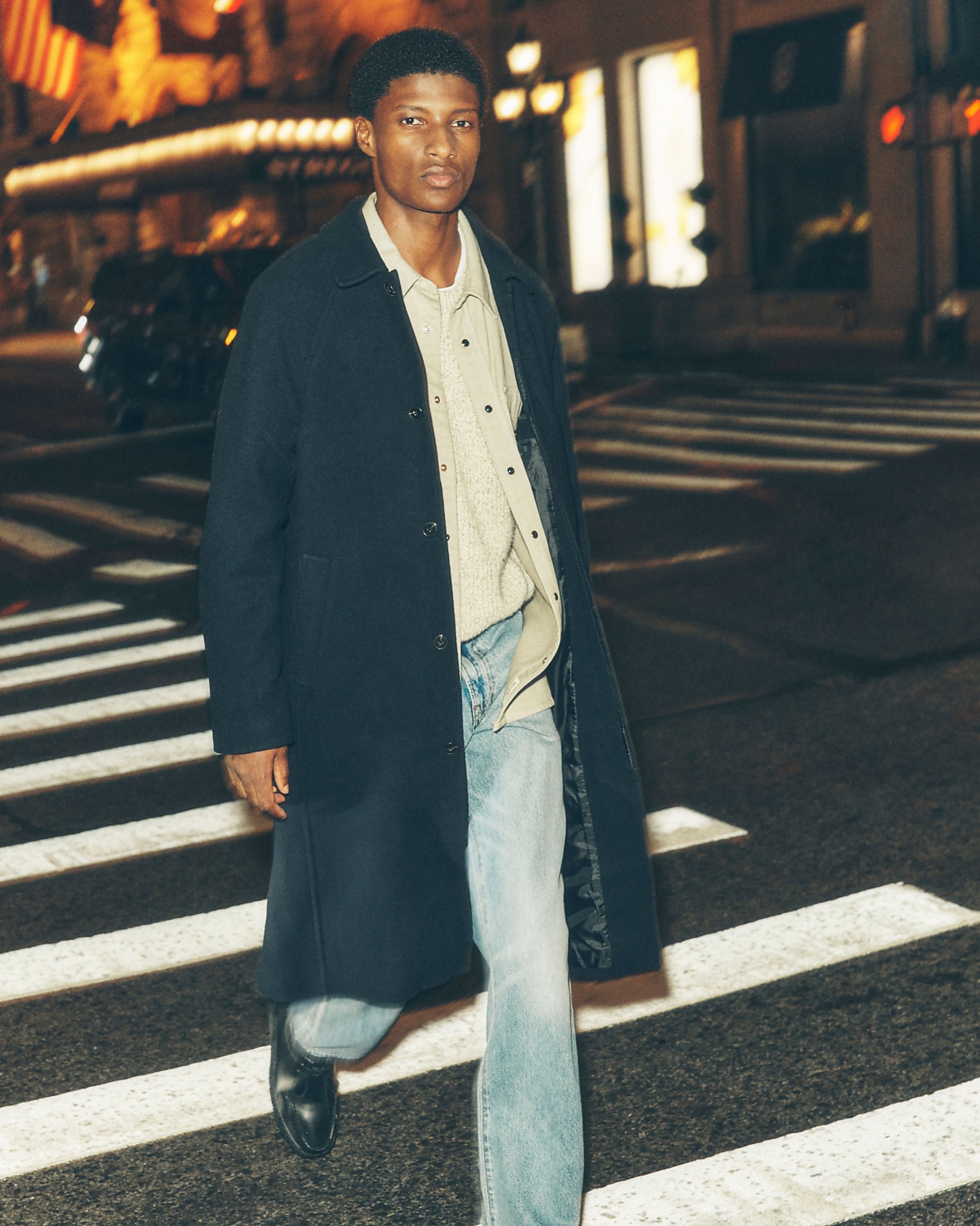 man wearing coat and jeans